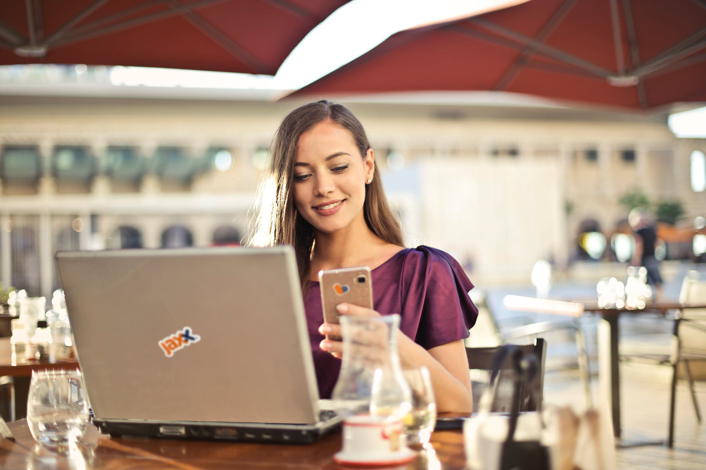 User managing Jaxx wallet on laptop and phone